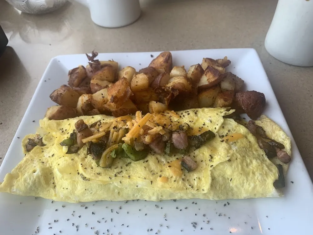 Two Eggs Fried Grits and Ham Bacon Hash or Sausage